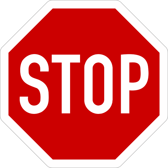 Red and white traffic sign saying STOP.
